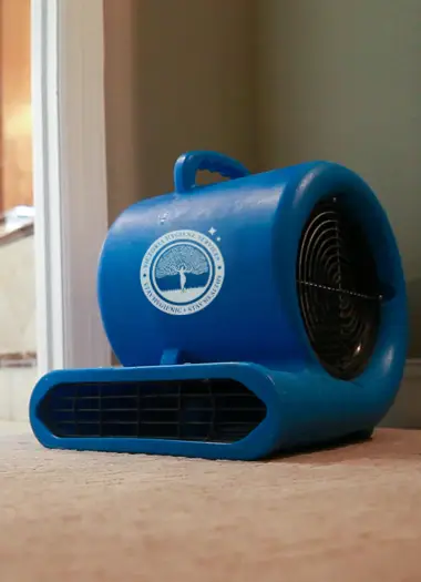 Air blower set up to dry moisture from a water-affected floor in a Melbourne home