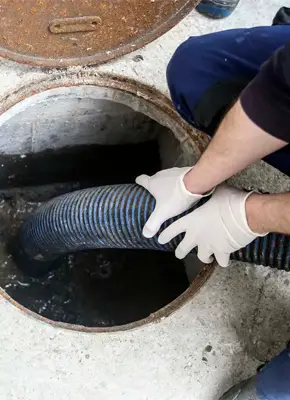 Technicians performing blocked sewage cleanup at a residential site in Victoria