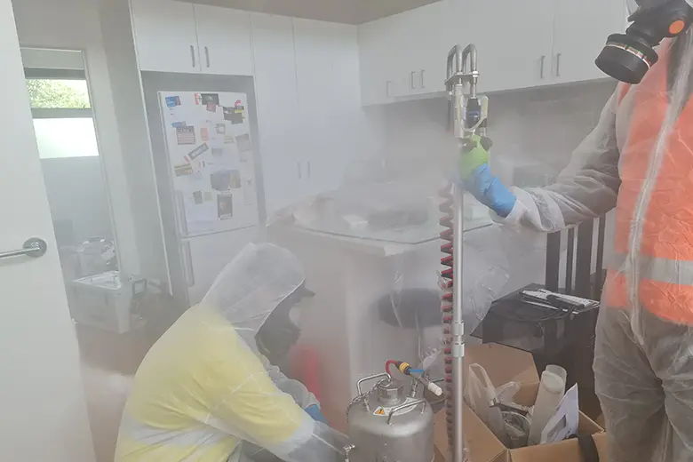 Specialists disinfecting and cleaning a contaminated area after sewer backup in Victoria