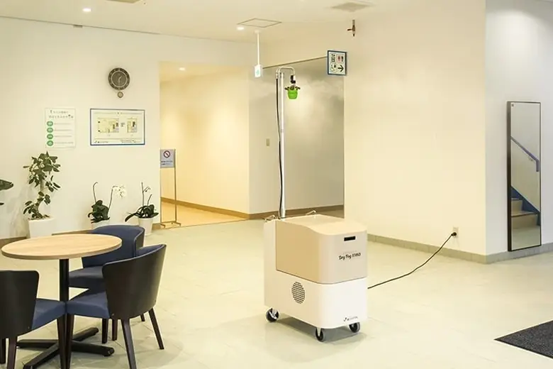 Technicians sealing a contaminated room for dry fog disinfection