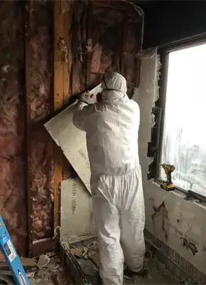 Restoration crew repairing and restoring a fire-damaged property