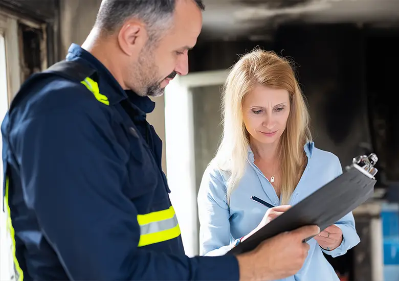 Technician performing final inspection after fire damage restoration