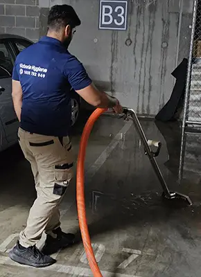 Technicians extracting flood water from a Melbourne home using industrial equipment