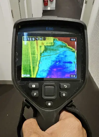 Restoration expert conducting moisture testing in a water-damaged Melbourne property