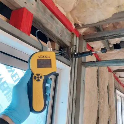 Technician collecting air sample for mould testing in a Melbourne property