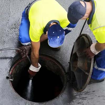 Technician in protective suit cleaning sewage in Melbourne
