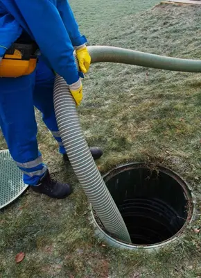 Technician using equipment to clean a blocked sewage drain at a Melbourne property