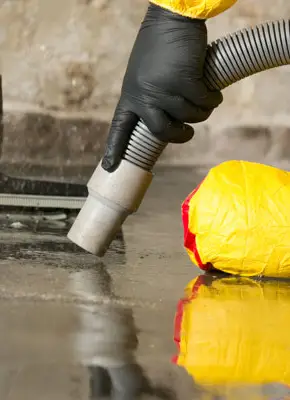 Certified technicians cleaning sewer waste from a flooded area in a Melbourne property