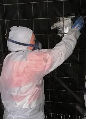 Technician cleaning soot from a fire-damaged property in Victoria