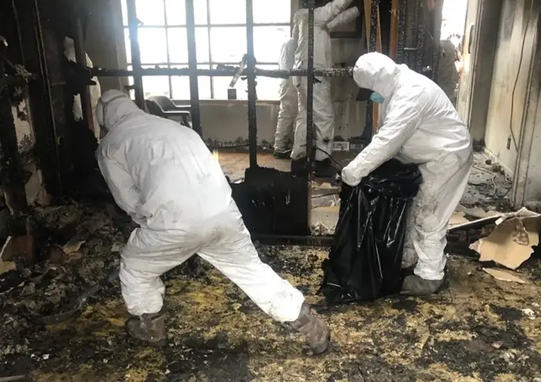 Trained professionals using protective gear to handle hazardous waste