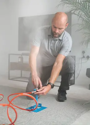 Technician performing dry fog disinfection in residential space