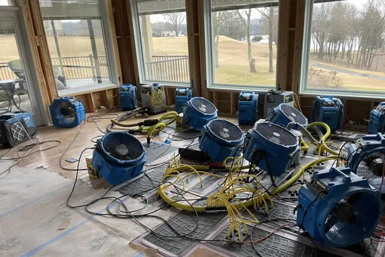 Dehumidifiers and air movers set up to dry structural components after water extraction in a Melbourne property