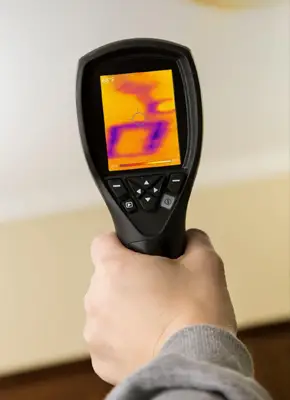 Technician using thermal imaging to detect water leaks inside wall and ceiling surfaces in a Melbourne home