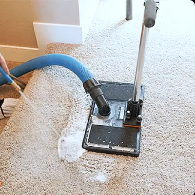 Technician drying and steam cleaning a water-damaged carpet in a Melbourne home