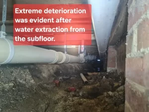 Inspection of the area below the subfloor of a water damaged house in Melbourne, showing signs of moisture and decay.