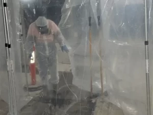 Technician sealing off a mould affected area in a Melbourne property to prevent cross contamination during remediation.