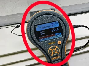 Moisture meter showing dampness in a window frame during inspection of a Melbourne property.