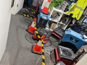 Technician preparing water damage restoration equipment inside a water damaged apartment in Melbourne