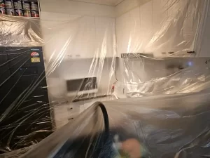 Sealed kitchen area in a Melbourne home affected by water damage and mould to contain contamination during restoration.