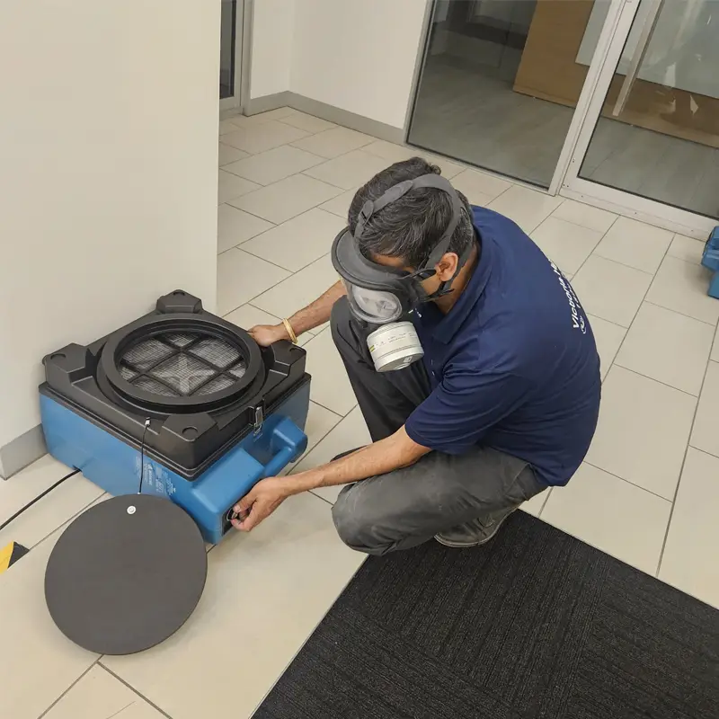 Technician setting up an air mover to dry a water damaged apartment in Melbourne.