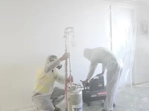 Technician setting up a dry fog disinfection machine inside a sealed room for deep sanitization in a Melbourne property.