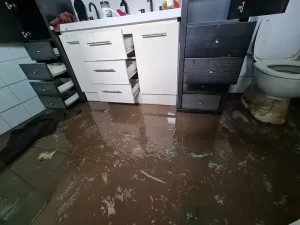 Bathroom affected by a sewer outburst showing water and sewage damage in a Melbourne property.