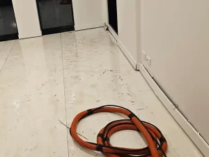 Swollen and damp skirtings in a Melbourne apartment caused by flooding from a water leak.