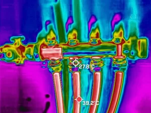 Thermal imaging device detecting hidden water leak inside a wall during inspection in a Melbourne property.