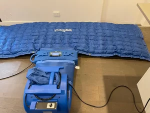 Drying equipment in use on a timber floor affected by water damage in a Melbourne property.