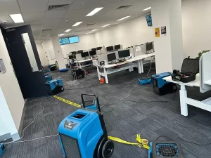Ongoing water and flood damage restoration work in a Melbourne property using professional drying and extraction equipment.