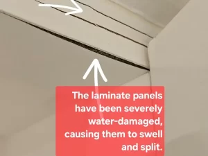 Swollen and discoloured laminate panels showing visible signs of water damage in a Melbourne property.