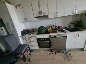 Water damaged kitchen in a Melbourne property caused by a ceiling burst, with visible signs of water saturation and ceiling collapse.