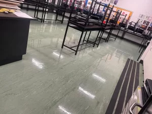 Water pooled on the floor of a flooded classroom in Melbourne awaiting emergency restoration services.