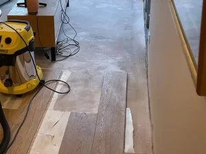 Removal of water damaged timber flooring from a Melbourne property during a professional restoration process.